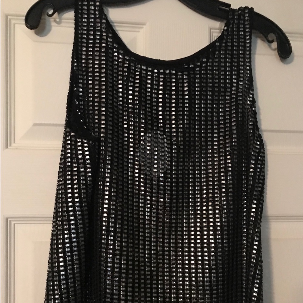 Metallic Silver and Black sleeveless shirt.